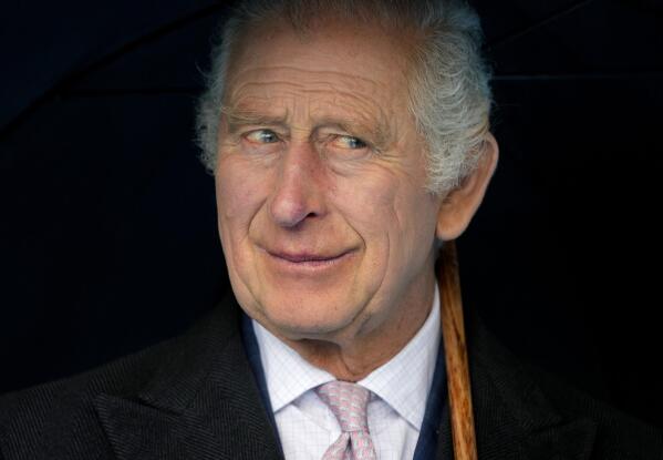 FILE - Britain's King Charles III smiles during a boat trip, in Hamburg, Germany, Friday, March 31, 2023. King Charles III arrived Wednesday for a three-day official visit to Germany. Britain’s royal family turns the page on a new chapter with the coronation of King Charles III. Charles ascended the throne when his mother, Queen Elizabeth II, died last year. But the coronation Saturday is a religious ceremony that provides a more formal confirmation of his role as head of state and titular head of the Church of England. (AP Photo/Matthias Schrader, Pool, File)