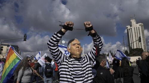 FILE - A protester wearing a rubber mask depicting Israeli Prime Minister Benjamin Netanyahu demonstrates in front of the Supreme Court in Jerusalem against the appointment of Aryeh Deri, the leader of the ultra-Orthodox Shas party as the country's new health minister, Thursday, Jan, 5, 2023. (AP Photo/Mahmoud Illean, File)