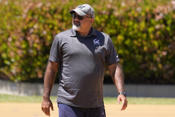 California track and field coach Mohamad Saatara watches as athletes practice in Berkeley, Calif., Thursday, May 2, 2024. Saatara is at the center of a diverse team of throwers based in Northern California. The man known as Coach Mo hopes to have as many as 15 of his athletes at the Paris Olympics this summer representing multiple countries. (AP Photo/Jeff Chiu)