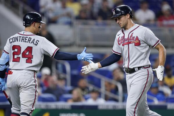 Atlanta Braves' Matt Olson, right, is congratulated by William Contreras (24) after Olson hit a home run during the fourth inning of a baseball game against the Miami Marlins, Friday, Aug. 12, 2022, in Miami. (AP Photo/Wilfredo Lee)