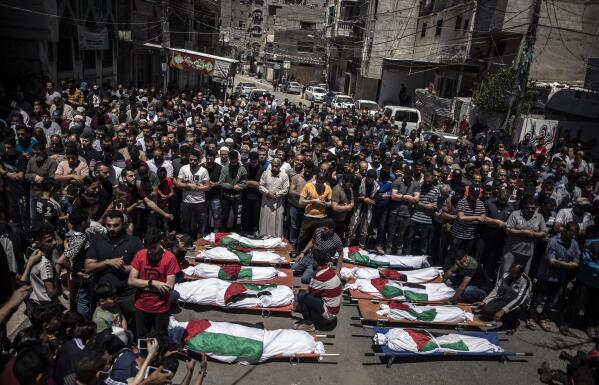 Palestinians attend the funeral of two women and eight children of the Abu Hatab family in Gaza City, who were killed after an Israeli air strike, Saturday, May 15, 2021. (AP Photo/Khalil Hamra)