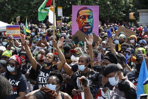 FILE - People participate in a Caribbean-led Black Lives Matter rally on June 14, 2020, at Brooklyn's Grand Army Plaza in New York. On Wednesday, July 19, 2023, New York City agreed to pay more than $13 million to settle a civil rights lawsuit brought on behalf of roughly 1,300 people who were arrested or beaten by police during racial injustice demonstrations that swept through the city during the summer of 2020. (AP Photo/Kathy Willen, File)