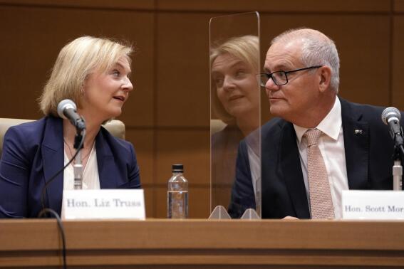 Former British Prime Minister Liz Truss, left, and former Prime Minister of Australia, Scott Morrison, right, speak during a symposium of the Inter-Parliamentary Alliance on China (IPAC) at the Diet Members Building Friday, Feb. 17, 2023, in Tokyo. (AP Photo/Eugene Hoshiko)