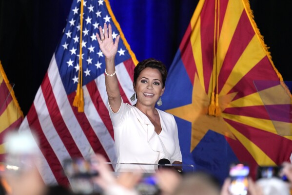 Republican Arizona Senate candidate Kari Lake waves to supporters as she arrives on stage after being declared the primary winner Tuesday, July 30, 2024, in Phoenix. (AP Photo/Ross D. Franklin)