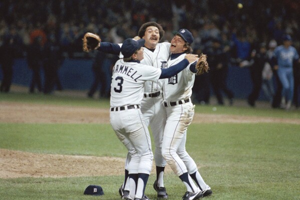 FILE - Detroit's Alan Trammell, left, Willie Hernandez and Darrell Evans, right, celebrate after they beat the Kansas City Royals 1-0 to win the American League Championship in Detroit, Oct. 5, 1984. Three-time All-Star relief pitcher Hernández, who won the 1984 Cy Young and Most Valuable Player awards as part of the World Series champion Detroit Tigers, has died. He was 69. (AP Photo/Mark Duncan, File)