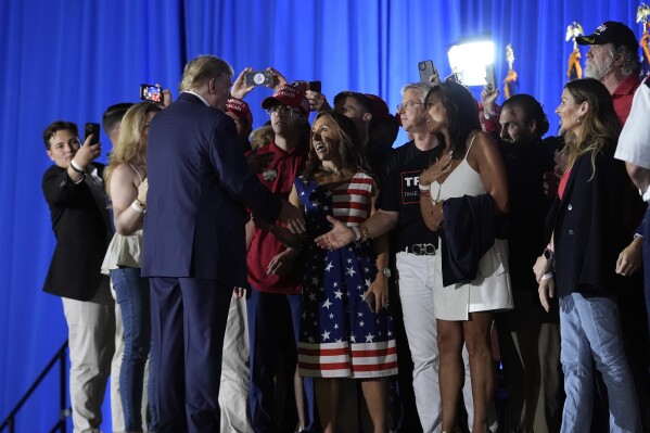 Republican presidential candidate former President Donald Trump greets supporters after speaking at his birthday celebration, hosted by Club 47, in West Palm Beach, Fla., Friday, June 14, 2024. (AP Photo/Gerald Herbert)