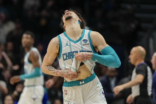 Charlotte Hornets guard LaMelo Ball celebrates their teams win against the Washington Wizards in an NBA basketball game on Wednesday, Nov. 22, 2023, in Charlotte, N.C. The Hornets won 117-114. (AP Photo/Chris Carlson)