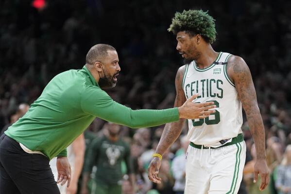 Boston Celtics head coach Ime Udoka, left, speaks with Celtics guard Marcus Smart, right, as the team leads the Milwaukee Bucks during the second half of Game 7 of an NBA basketball Eastern Conference semifinals playoff series, Sunday, May 15, 2022, in Boston. (AP Photo/Steven Senne)