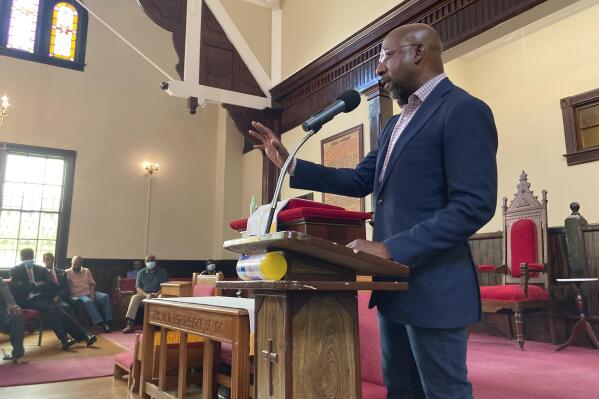 FILE - Sen. Raphael Warnock, D-Ga., who is the pastor of Ebenezer Baptist Church in Atlanta, campaigns at a church by the same name in Eatonton, Ga., on Aug. 18, 2022. Warnock and his Republican challenger Herschel Walker both tout faith in their public lives but they offer vastly different visions and applications of Christianity. Warnock hails from the Black church tradition of social action. Walker, who is also Black, aligns more with the cultural conservatism of white evangelicals who have shaped the modern Republicans Party. (AP Photo/Bill Barrow)