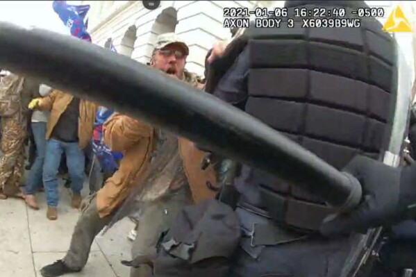 FILE - This image from video from a police worn body camera from the Jan. 6, 2021, riot at the U.S. Capitol, released by the Justice Department in the statement of facts supporting the arrest of Kenneth Joseph Owen Thomas, shows Thomas. Thomas, an Ohio man who repeatedly attacked police officers at the U.S. Capitol during a mob's riot on Jan. 6, 2021, has been sentenced to nearly five years in prison.(Justice Department via AP)