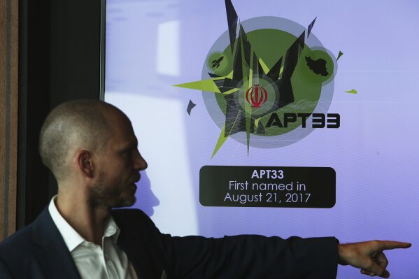 
              Alister Shepherd, the director of a subsidiary of the cybersecurity firm FireEye, gestures during a presentation about the APT33 hacking group, which his firm suspects are Iranian government-aligned hackers, in Dubai, United Arab Emirates, Tuesday, Sept. 18, 2018. FireEye warned Tuesday that Iranian government-aligned hackers have stepped up their efforts in the wake of President Donald Trump pulling America from the nuclear deal. (AP Photo/Jon Gambrell)
            