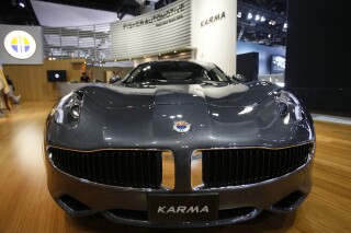 FILE - Fisker Automotive's Fisker Karma, a sports luxury plug-in hybrid car, is displayed at the 2010 Los Angeles Auto Show in Los Angeles, Nov. 18, 2010. Electric vehicle maker Fisker has filed for Chapter 11 bankruptcy protection in a period when even the top manufacturers in the industry are struggling. Its operating subsidiary, Fisker Group Inc., said in its filing that its estimated assets were between $500 million and $1 billion. (AP Photo/Damian Dovarganes, File)