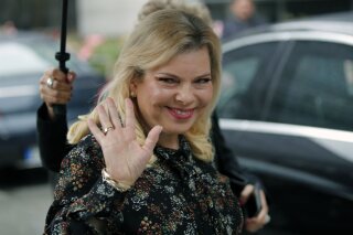FILE - In this June 6, 2018 file photo, Sara Netanyahu, the wife of Israel's Prime Minister Benjamin Netanyahu, arrives for the meeting with French Finance Minister Bruno Le Maire at Bercy Economy Ministry, in Paris, France. A Jerusalem magistrate court on Sunday, June 16, 2019, sentenced Netanyahu, to pay a fine of more than $15,000 for misusing state funds. The sentencing comes after she agreed to a plea bargain that ended the years-long saga of just one of the high-profile corruption cases involving the prime minister's family. (AP Photo/Francois Mori, File)