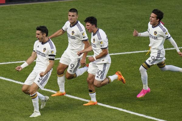 LA Galaxy midfielder Gastón Brugman, left, celebrates with teammates after scoring on a penalty kick against Real Salt Lake during the first half of an MLS soccer match Wednesday, May 31, 2023, in Sandy, Utah. (AP Photo/Rick Bowmer)