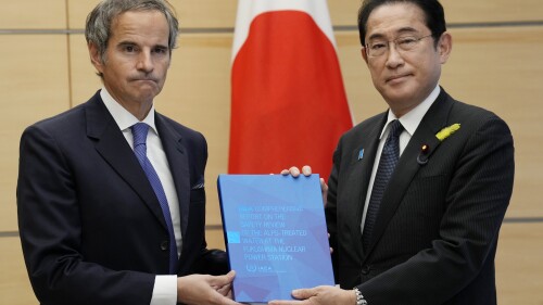 Rafael Mariano Grossi, Director General of the International Atomic Energy Agency, left, presents IAEA's comprehensive report on Fukushima Treated Water Release to Japanese Prime Minister Fumio Kishida, right, at the prime minister's office Tuesday, July 4, 2023 in Tokyo. (AP Photo/Eugene Hoshiko, Pool)