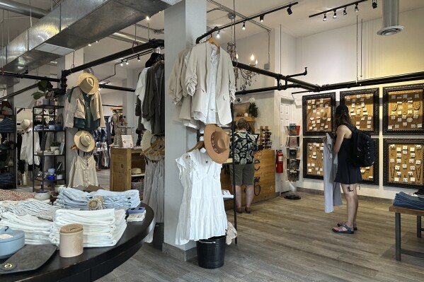 Shoppers wait to purchase items in a boutique on Tennyson Street Saturday, Aug. 5, 2023, in northwest Denver. On Thursday, the Commerce Department releases U.S. retail sales data for August.(AP Photo/David Zalubowski)