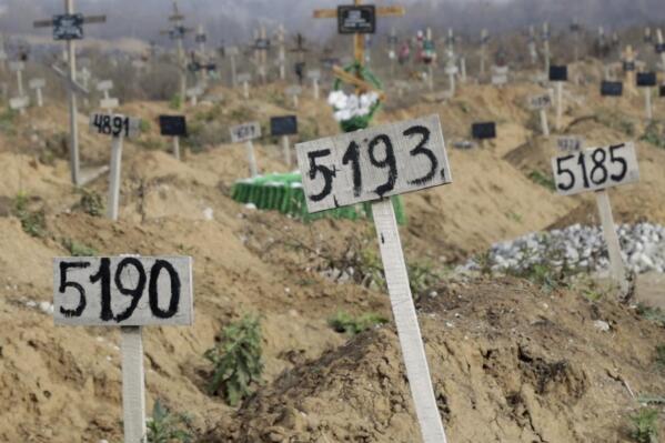 This Nov. 16, 2022 image from video shows some of the new graves which have been dug since the Russian siege began, at the Staryi Krym cemetery on the outskirts of the occupied Ukrainian city of Mariupol. Most are marked only by number. The Associated Press estimated at least 10,300 new graves in and around Mariupol — 8,500 in this cemetery — by analyzing satellite imagery from early March through December, noting sections where the earth had been disturbed. (AP Photo)