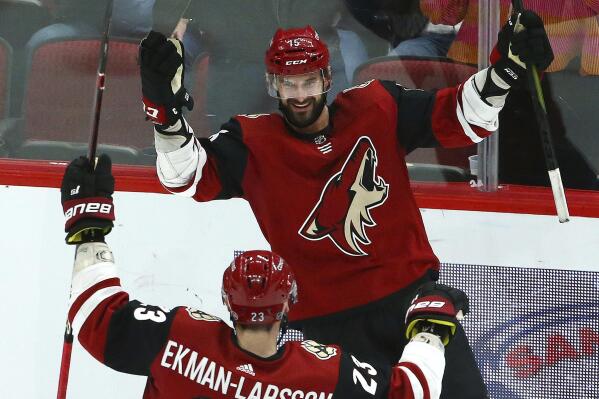 Arizona Coyotes center Brad Richardson (15) smiles as he celebrates his hat trick against the Vancouver Canucks with defenseman Oliver Ekman-Larsson (23) during the second period of an NHL hockey game Thursday, Feb. 28, 2019, in Glendale, Ariz. (AP Photo/Ross D. Franklin)