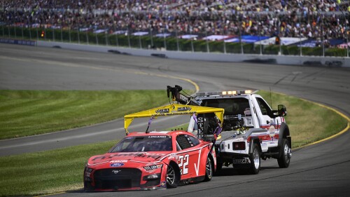 Joey Logano is towed back to the pits after an accident during a NASCAR Cup Series auto race at Pocono Raceway, Sunday, July 23, 2023, in Long Pond, Pa. (AP Photo/Derik Hamilton)