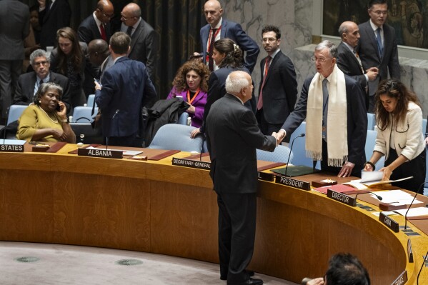Palestinian Observer to the United Nations, Riyad Mansour, faces and shakes hands with Security Council President and Brazilian Ambassador to the United Nations Sergio Franca Danese before members of the the U.N. Security Council went into closed consultations at United Nations headquarters Monday, Oct. 16, 2023. A planned vote on dueling resolutions on the Israel-Hamas war was delayed as a result, but the council remained in session. (AP Photo/Craig Ruttle)