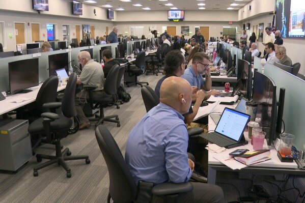 In this image taken from video, Florida Power Light employees work inside the company's command center during a hurricane storm drill in West Palm Beach, Fla., Thursday, May 9, 2024. The company is preparing for this year's hurricane season by pretending a major storm already hit. (AP Photo/Cody Jackson)