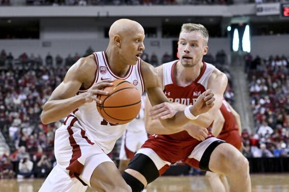 Arkansas guard Jordan Walsh tries to drive past Bradley forward Rienk Mast during the first half of an NCAA college basketball game, Saturday, Dec. 17, 2022, in North Little Rock, Ark. (AP Photo/Michael Woods)