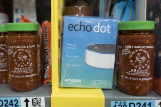 
              FILE - This Dec. 20, 2017, file photo shows the Amazon Echo Dot stocked on a shelf alongside jars of Garlic Chili Sauce at the Amazon Prime warehouse in New York. Consumer advocates say the kids’ version of Amazon’s Alexa won’t forget what children tell it, even after parents try to delete the conversations. A coalition of groups on Thursday, May 9, 2019, is planning to ask the Federal Trade Commission to investigate whether Amazon is holding onto children’s voice recordings and personal information longer than it should. (AP Photo/Mark Lennihan, File)
            