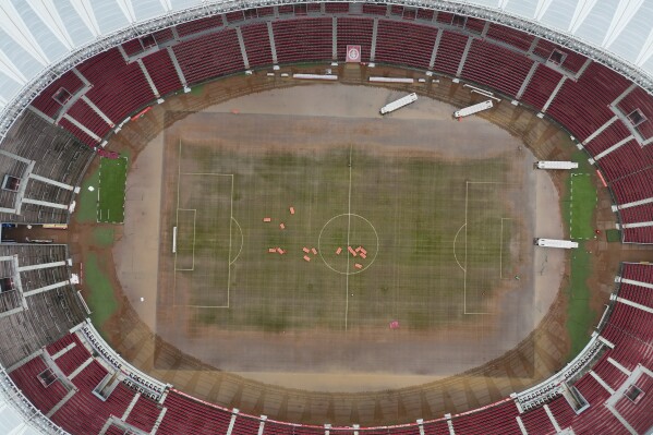 Seats are scattered in the field of the Beira Rio stadium after the waters that covered it during floods caused by heavy rains began to recede in Porto Alegre, Rio Grande do Sul state, Brazil, Sunday, May 12, 2024. (AP Photo/Andre Penner)