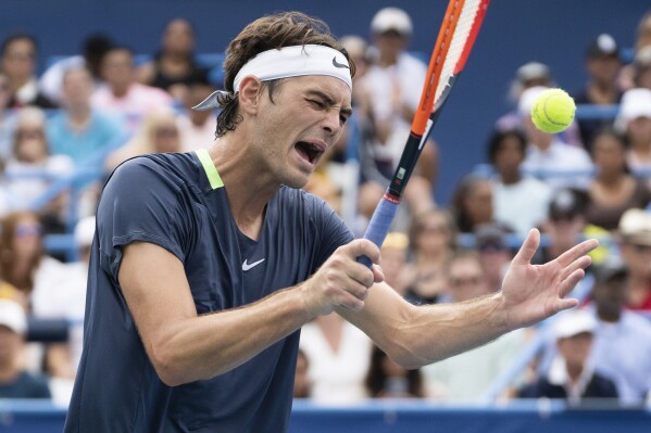 Taylor Fritz hits the extra ball from his pocket after losing a game against Andy Murray during the DC Open tennis tournament Friday, Aug. 4, 2023, in Washington. (Minh Connors/The Washington Post via AP)
