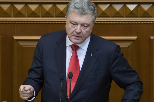 
              Ukrainian President Petro Poroshenko gestures during a parliament session in Kiev, Ukraine, Monday, Nov. 26, 2018. Ukraine's president on Monday urged parliament to impose martial law in the country to fight "growing aggression from Russia," after a weekend naval confrontation off the disputed Crimean Peninsula in which Russia fired on and seized three Ukrainian vessels amid renewed tensions between the neighbors. (Mykola Lazarenko, Presidential Press Service via AP)
            