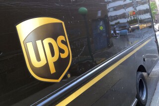FILE - A United Parcel Service truck is parked on a street, in New York, Thursday, May 11, 2023. Shares of UPS are falling before the market open on Tuesday, Jan. 30, 2024, as the package delivery company gave a weaker-than-expected full-year revenue forecast. (AP Photo/Richard Drew, File)