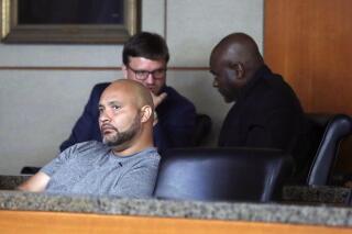 FILE - In this Aug. 23, 2019 file photo, former Houston police officers Steven Bryant, foreground, and Gerald Goines, background, turn themselves in at the Civil Courthouse, in Houston.  Bryant, pleaded guilty Tuesday, June 1, 2021, to federal charges in the deaths of two homeowners killed in a 2019 drug raid, admitting he lied and obstructed the resulting investigation. (Karen Warren/Houston Chronicle via AP, File)