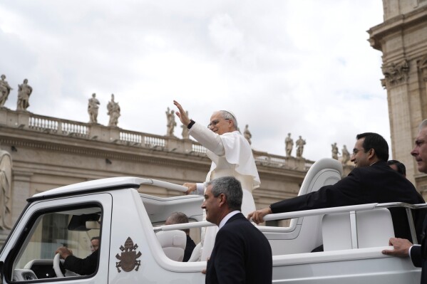 Pope Leo XIV waves as he leaves after his first weekly general audience in St. Peter's Square at The Vatican, Wednesday, May 21, 2025. (AP Photo/Gregorio Borgia)