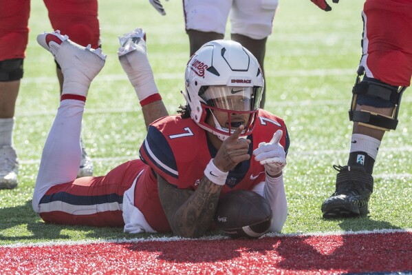 Liberty's Kaidon Salter lies down after running the ball for a touchdown against UMass during the first half of an NCAA college football game, Saturday, Nov. 18, 2023, in Lynchburg, Va. (AP Photo/Robert Simmons)