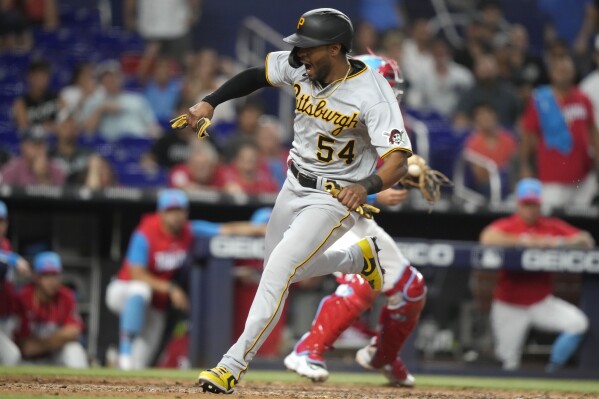 Pittsburgh Pirates' Josh Palacios (54) scores on a single hit by Ke'Bryan Hayes during the tenth inning of a baseball game against the Miami Marlins, Saturday, June 24, 2023, in Miami. (AP Photo/Lynne Sladky)
