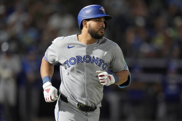 Toronto Blue Jays' Anthony Santander runs to first base after his single off Tampa Bay Rays pitcher Garrett Cleavinger during the sixth inning of a baseball game Saturday, May 24, 2025, in Tampa, Fla. (AP Photo/Chris O'Meara)