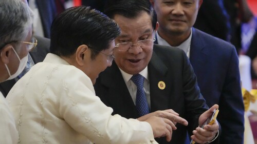 FILE -Cambodia Prime Minister Hun Sen, right, shows a mobile device to Philippine's President Ferdinand Marcos, Jr., during the ASEAN - South Korea Summits (Association of Southeast Asian Nations) in Phnom Penh, Cambodia, Friday, Nov. 11, 2022. Cambodia’s Prime Minister Hun Sen, a devoted and very active user of Facebook, says he will no longer upload to the platform, and instead depend on the Telegram app for getting his message across. (AP Photo/Anupam Nath, File)