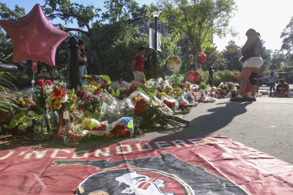Students gather on a stretch of sidewalk near the center of the Florida State campus in sight of the Student Union building, Tallahassee, Fla., Friday, April 18, 2025. (AP Photo/Gary McCullough)