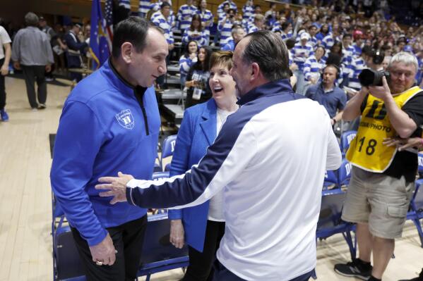 Former Duke head coach Mike Krzyzewski, left, and his wife, Mickie, laugh with Notre Dame head coach Mike Brey, right, before an NCAA college basketball game game in Durham, N.C., Tuesday, Feb. 14, 2023. (Ethan Hyman/The News & Observer via AP)