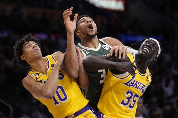 Milwaukee Bucks forward Giannis Antetokounmpo, center, battles for a rebound with Los Angeles Lakers guard Max Christie, left, and forward Wenyen Gabriel during the first half of an NBA basketball game Thursday, Feb. 9, 2023, in Los Angeles. (AP Photo/Mark J. Terrill)