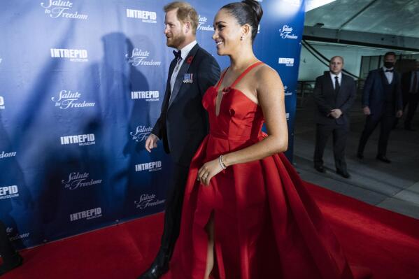 FILE - Prince Harry and Meghan Markle, Duke and Duchess of Sussex, arrive at the Intrepid Sea, Air & Space Museum for the Salute to Freedom Gala Wednesday, Nov. 10, 2021, in New York. The Duchess of Sussex has apologized for misleading a British court about the extent of her cooperation with the authors of a sympathetic book about her and Prince Harry. The former Meghan Markle sued a U.K. newspaper for publishing a letter she wrote to her estranged father, Thomas Markle.  (AP Photo/Craig Ruttle)