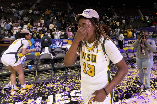 Norfolk State Skye Robinson (13) wipes tears from her eyes after Norfolk State defeated Howard 51-46 in the championship of the Mid-Eastern Athletic Conference tournament in Norfolk, Va., on Saturday, March 16, 2024. (Billy Schuerman/The Virginian-Pilot via AP)