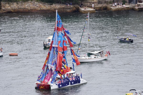 A yacht is adorned with flags and banners as it sails on the harbor during Australia Day celebrations in Sydney, Friday, Jan. 26, 2024. (AP Photo/Rick Rycroft)