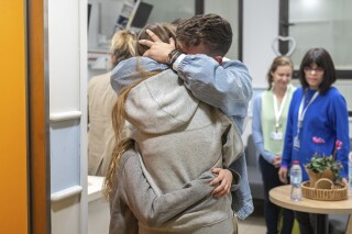 This handout photo provided by GPO on Friday, Dec. 1, 2023, shows Israeli released hostage Mia Shem reuniting with her family at Sheba Medical Center in Tel Hashomer, Ramat Gan, Israel. Mia Shem was released the night of Thursday, Nov. 30, 2023. (GPO via AP)