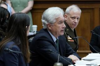 FILE - Central Intelligence Agency Director William Burns, center, testifies on Capitol Hill in Washington, March 8, 2022, during a House Permanent Select Committee on Intelligence hearing on worldwide threats. He is flanked by Director of National Intelligence Avril Haines, left, and Defense Intelligence Agency Director Lt. Gen. Scott Berrier, right. Burns has tested positive for COVID-19, according to an agency statement Thursday, March 31. (AP Photo/Susan Walsh, File)