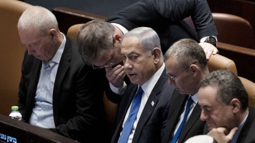 Lawmakers surround Israel's Prime Minister Benjamin Netanyahu, center, at a session of the Knesset, Israel's parliament, in Jerusalem, Monday, July 24, 2023. (AP Photo/Maya Alleruzzo)