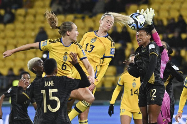 Sweden's Amanda Ilestedt heads the ball into the hands of South Africa's goalkeeper Kaylin Swart during the Women's World Cup Group G soccer match between Sweden and South Africa in Wellington, New Zealand, Sunday, July 23, 2023. (AP Photo/Andrew Cornaga)