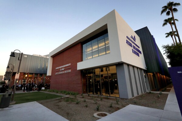 FILE - The Jerry Colangelo Museum at Grand Canyon University is seen at at dusk in Phoenix, on Sept. 20, 2017. The nation’s largest Christian university says it’s fighting a $37.7 million fine brought by the federal government over allegations that it lied to students about the cost of its programs. Grand Canyon University, which enrolls more than 100,000 students, said it’s filing an appeal with the U.S. Education Department on Thursday. (AP Photo/Matt York, File)