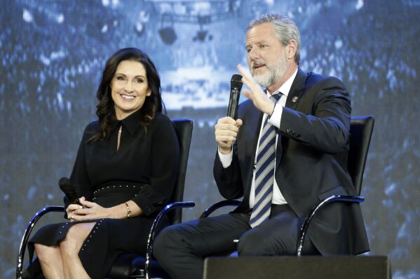Corrects to Becki not Becky - FILE -This Wednesday Nov. 28, 2018 file photo shows Rev. Jerry Falwell Jr., right, and his wife, Becki during after a town hall at a convocation at Liberty University in Lynchburg, Va. Falwell Jr. says he is seeking help for the "emotional toll" from an affair his wife had with a man who he says later threatened his family. (AP Photo/Steve Helber)