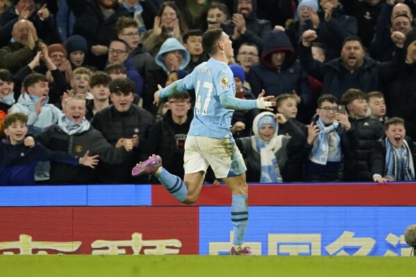 Manchester City's Phil Foden runs towards the fans as he celebrates after scoring his team's fourth goal and his own third of the match during the English Premier League soccer match between Manchester City and Aston Villa at the Etihad Stadium in Manchester, England, Wednesday, April 3, 2024. (AP Photo/Dave Thompson)